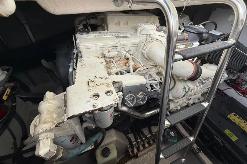 Slide: The Image of Engine compartment of a 2006 Sea Ray 48 Sundancer with visible machinery and ladder. - 97
