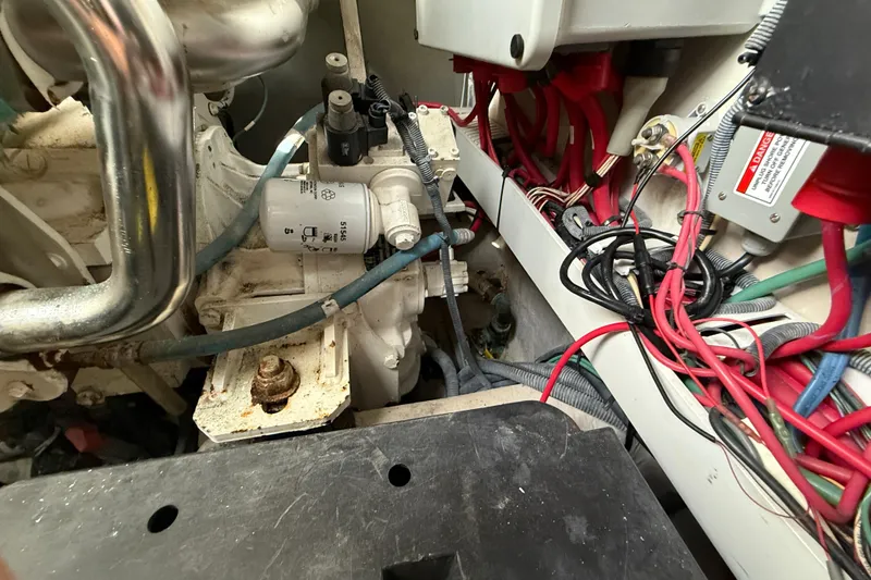 Slide: The Image of Engine compartment of 2006 Sea Ray 48 Sundancer with wiring and components visible. - 98