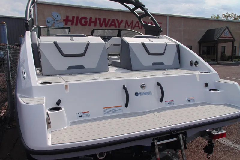 Slide: The Image of 2026 Yamaha Boats AR220 rear view with seating and swim platform. - 12