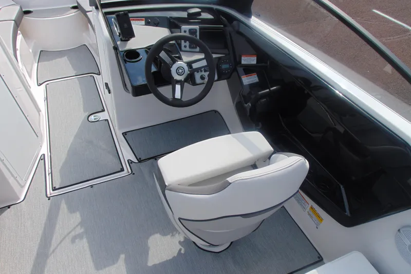 Slide: The Image of 2026 Yamaha Boats AR220 cockpit with steering wheel and captain's chair, featuring modern design. - 16