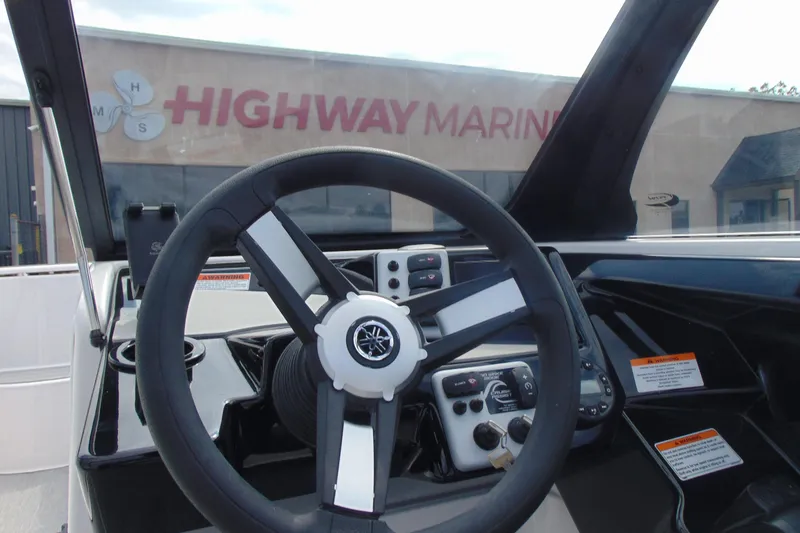 Slide: The Image of 2026 Yamaha AR220 boat dashboard with steering wheel at Highway Marine. - 18