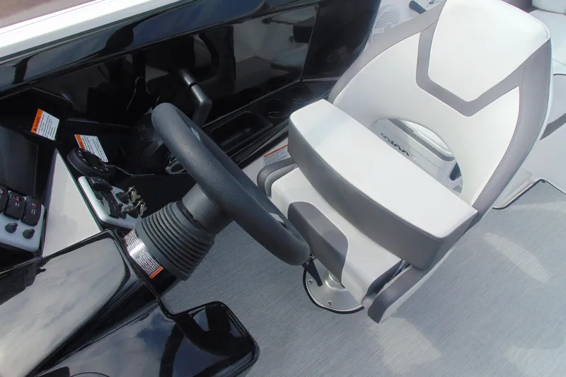 Slide: The Image of 2026 Yamaha Boats AR220 cockpit with steering wheel and captain's chair. - 19