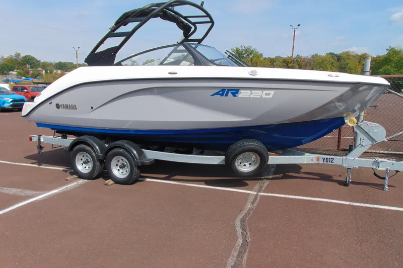 The Image of 2026 Yamaha Boats AR220 on trailer, parked outdoors, showcasing sleek design and modern features. - 9