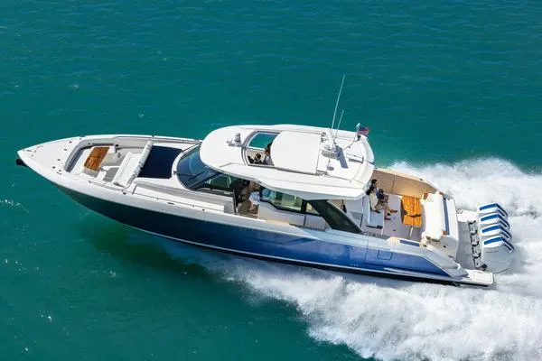 Slide: The Image of 2025 Tiara Yachts 56 LS cruising on clear blue water. - 1