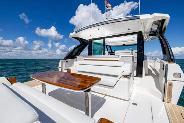 Slide: The Image of 2025 Tiara Yachts 56 LS luxury yacht with sleek design and spacious deck on open water. - 7