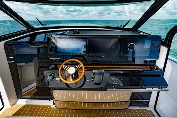 Slide: The Image of 2025 Tiara Yachts 56 LS helm with modern controls and ocean view. - 9