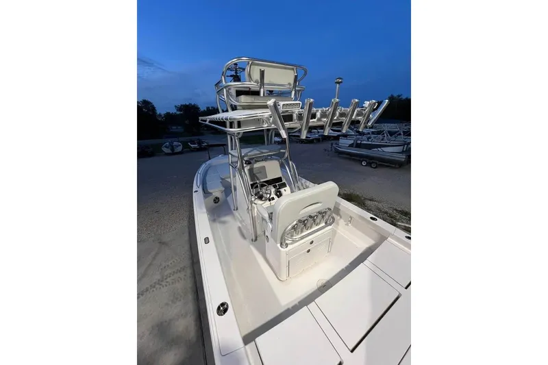 Slide: The Image of 2023 Pathfinder 2600 HPS boat with elevated helm and rod holders at dusk. - 10