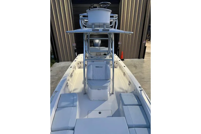 Slide: The Image of 2023 Pathfinder 2600 HPS boat with center console and seating, docked in a marina. - 12