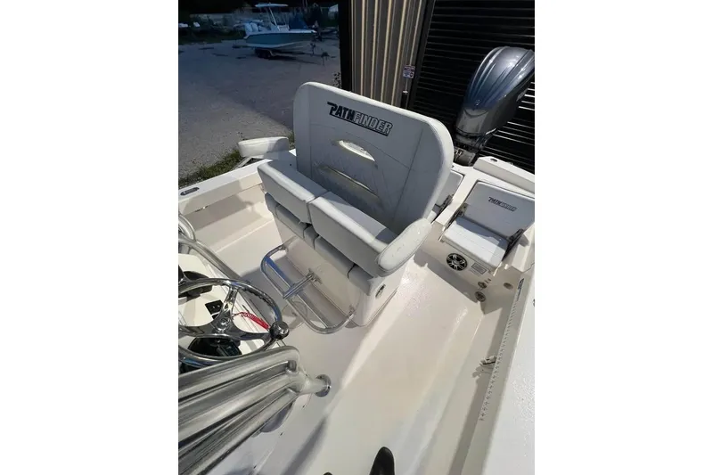Slide: The Image of 2023 Pathfinder 2600 HPS boat interior with seating and steering wheel. - 16
