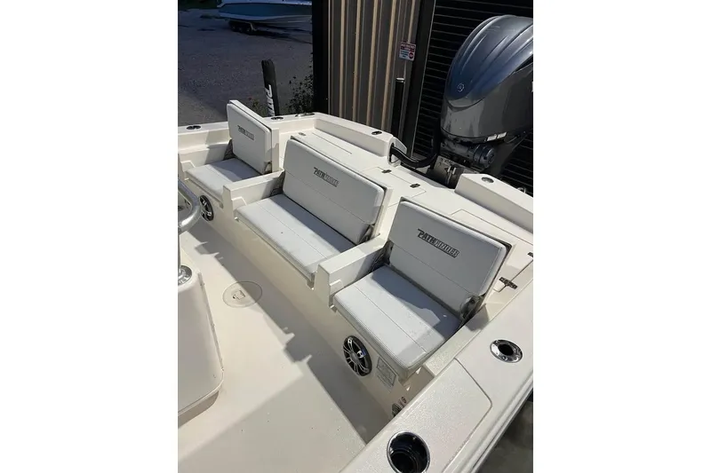 Slide: The Image of 2023 Pathfinder 2600 HPS boat interior with cushioned seating and motor. - 17