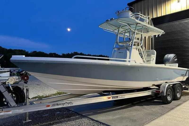 Slide: The Image of 2023 Pathfinder 2600 HPS boat on trailer at dusk, under a moonlit sky. - 3