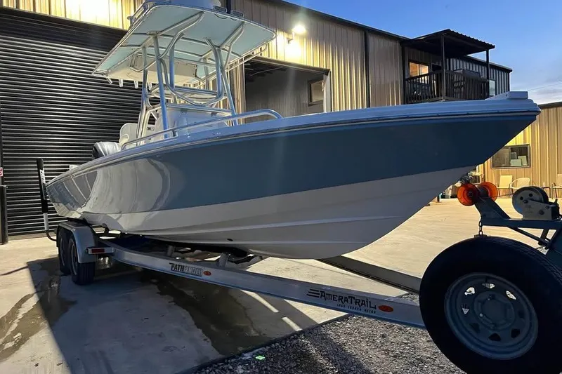 Slide: The Image of 2023 Pathfinder 2600 HPS boat on trailer outside a warehouse. - 5