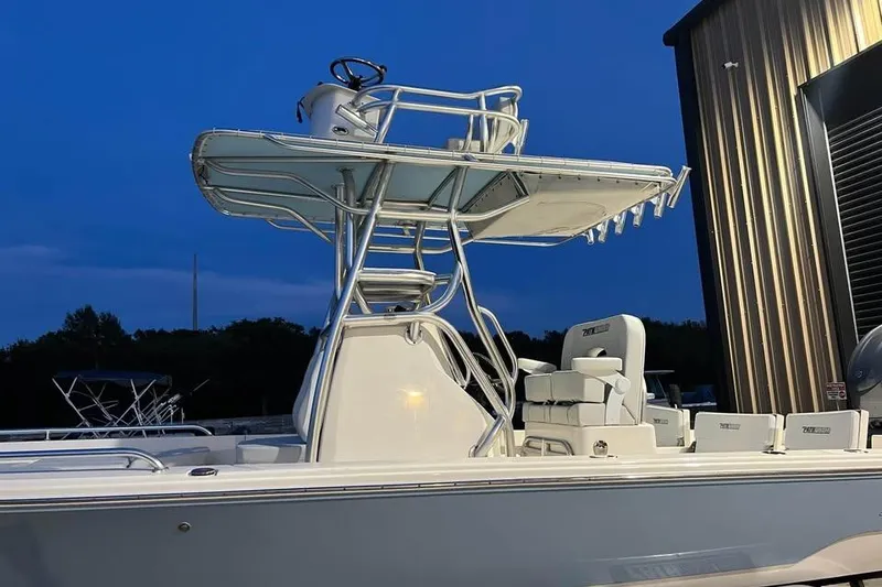 Slide: The Image of 2023 Pathfinder 2600 HPS boat with elevated helm, docked at twilight. - 7