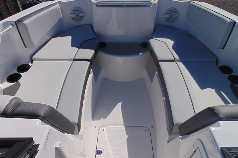 Slide: The Image of 2026 Yamaha Boats AR220 interior with spacious seating and cup holders. - 13