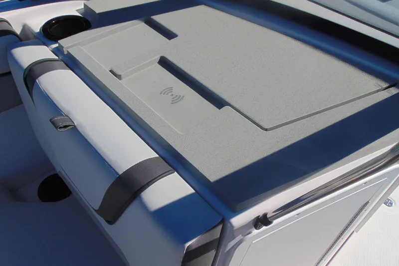 Slide: The Image of 2026 Yamaha Boats AR220 interior with wireless charging pad and cup holders. - 14