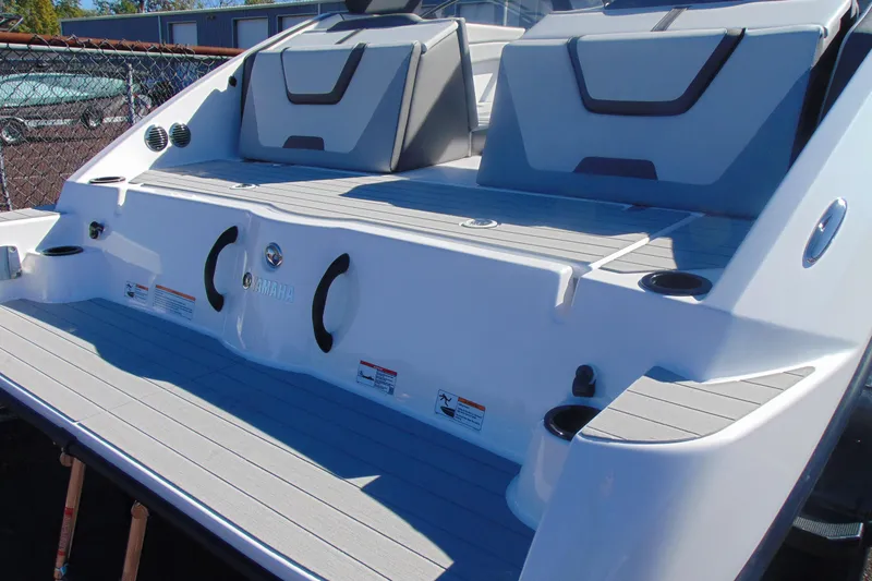 Slide: The Image of 2026 Yamaha Boats AR220 swim platform with seating and cup holders. - 4
