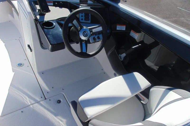 Slide: The Image of 2026 Yamaha Boats AR220 cockpit with steering wheel and seating. - 9
