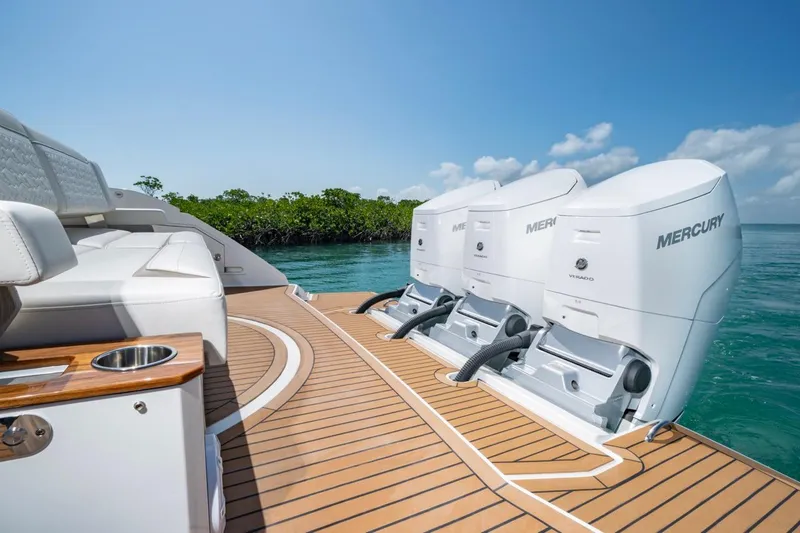 Slide: The Image of 2025 Tiara Yachts 48 LS with Mercury engines on teak deck, sunny day. - 5