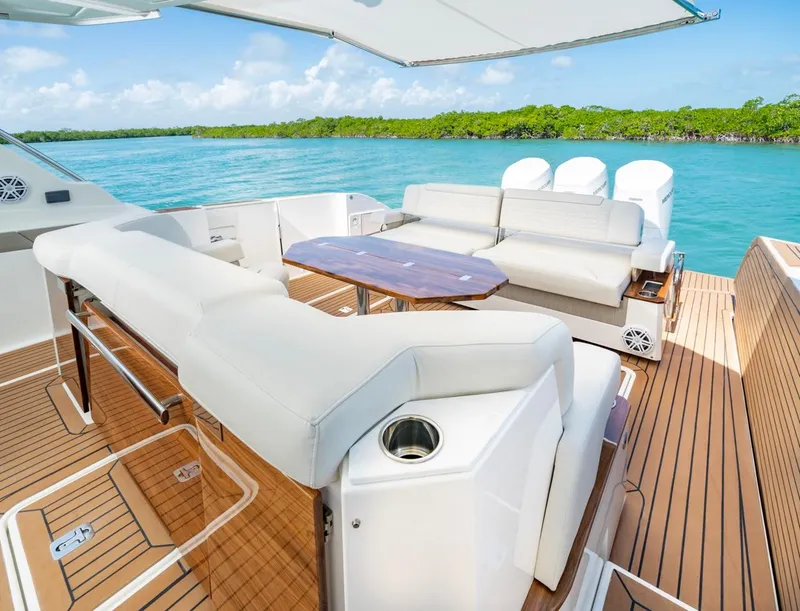 Slide: The Image of Luxurious 2025 Tiara Yachts 48 LS with spacious deck and seating, overlooking serene waters. - 7