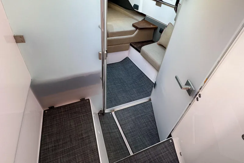 Slide: The Image of Interior of 2022 Axopar 37 Sun-Top boat, featuring modern seating and carpeted flooring. - 14
