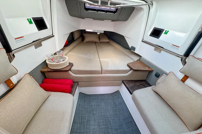 Slide: The Image of 2022 Axopar 37 Sun-Top cabin interior with cozy seating and modern design. - 16