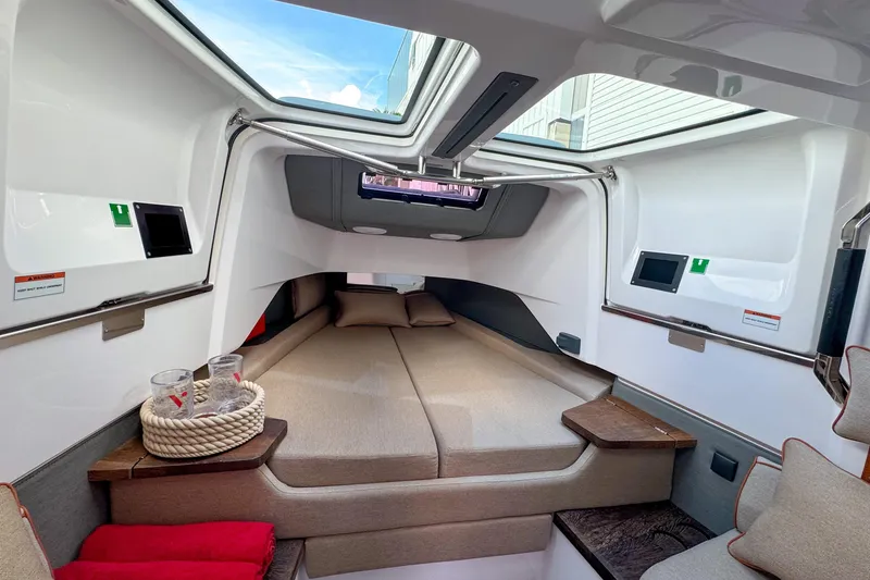Slide: The Image of Luxurious interior cabin of 2022 Axopar 37 Sun-Top boat with skylight and cozy bedding. - 17