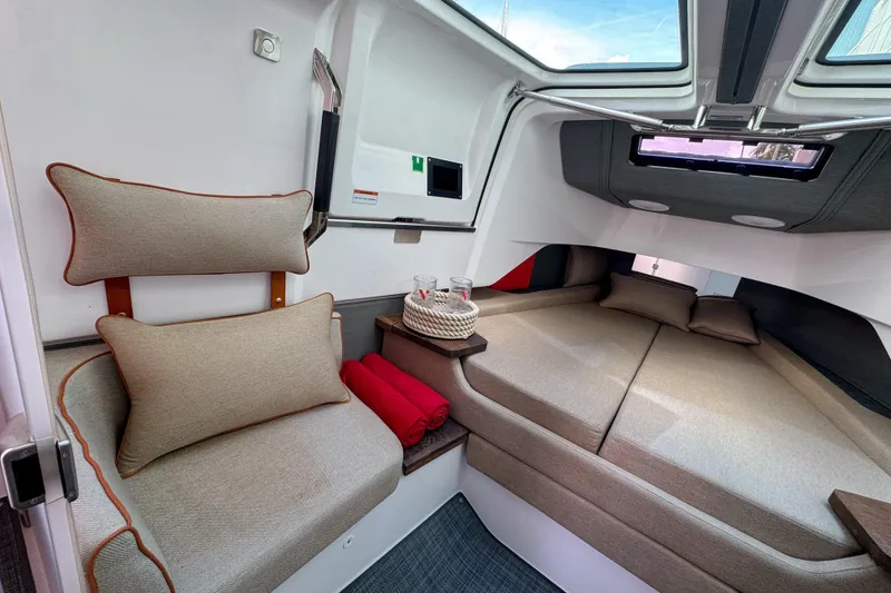 Slide: The Image of Luxurious interior of 2022 Axopar 37 Sun-Top boat with cozy seating and bedding. - 19