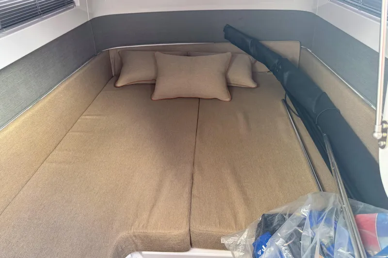Slide: The Image of Cozy cabin interior of 2022 Axopar 37 Sun-Top with beige cushions and pillows. - 20
