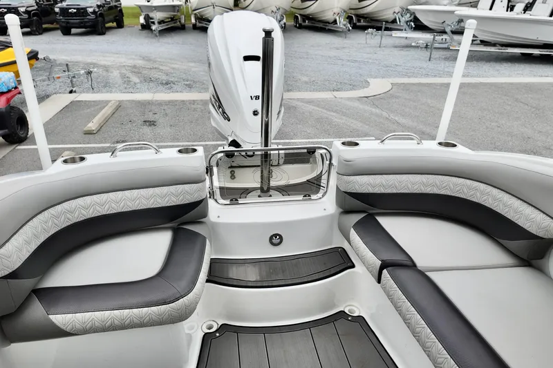 Slide: The Image of 2023 Hurricane Sun Deck 2690 boat interior with seating and outboard motor. - 14