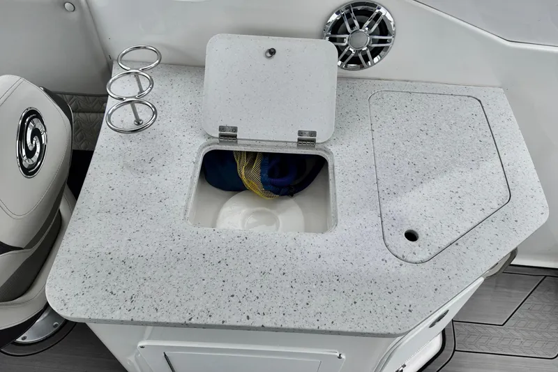 Slide: The Image of 2023 Hurricane Sun Deck 2690 boat interior with storage compartment and cup holders. - 16