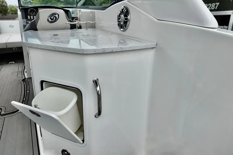 Slide: The Image of 2023 Hurricane Sun Deck 2690 boat interior with sleek countertop and storage compartment. - 20