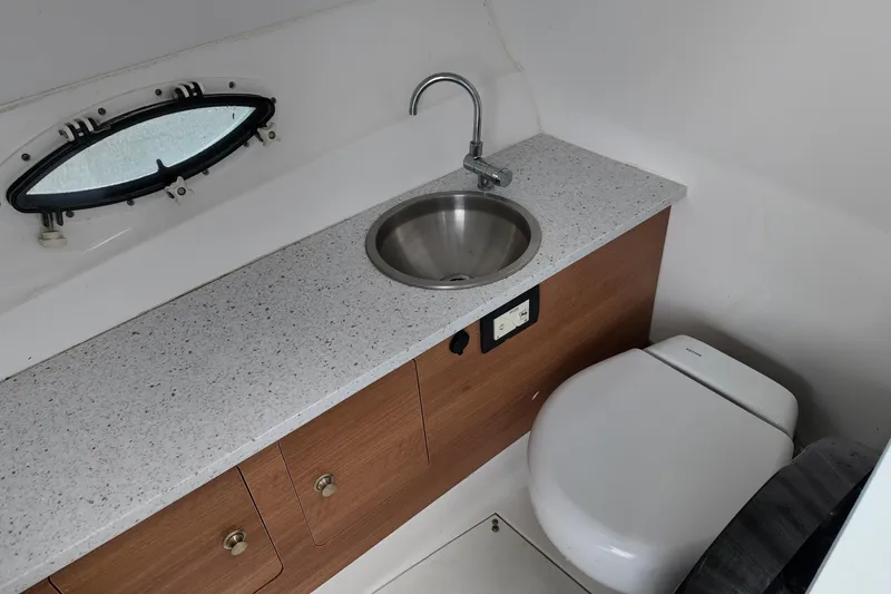 Slide: The Image of 2023 Hurricane Sun Deck 2690 boat bathroom with sink and toilet. - 22
