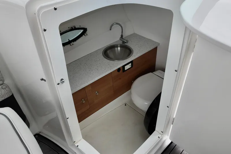Slide: The Image of 2023 Hurricane Sun Deck 2690 boat interior with sink and toilet. - 23