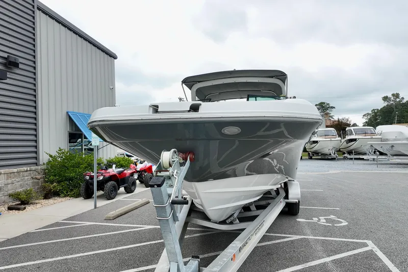 Slide: The Image of 2023 Hurricane Sun Deck 2690 boat on trailer in parking lot near building. - 4