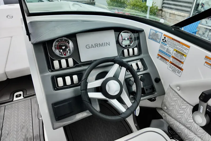 Slide: The Image of 2023 Hurricane Sun Deck 2690 boat dashboard with Garmin navigation system and steering wheel. - 8