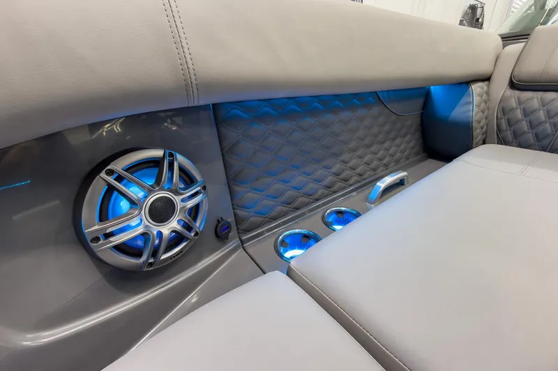 Slide: The Image of Luxurious interior of 2026 Godfrey Sanpan 27' Tritoon with blue LED lighting and speaker. - 16
