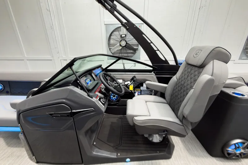 Slide: The Image of 2026 Godfrey Sanpan 27' Tritoon helm with luxurious seating and advanced controls. - 25