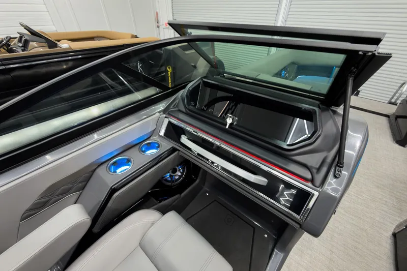 Slide: The Image of Interior of 2026 Godfrey Sanpan 27' Tritoon with modern dashboard and illuminated cup holders. - 28