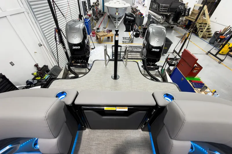 Slide: The Image of 2026 Godfrey Sanpan 27' Tritoon with twin Suzuki 350 engines in a workshop setting. - 38