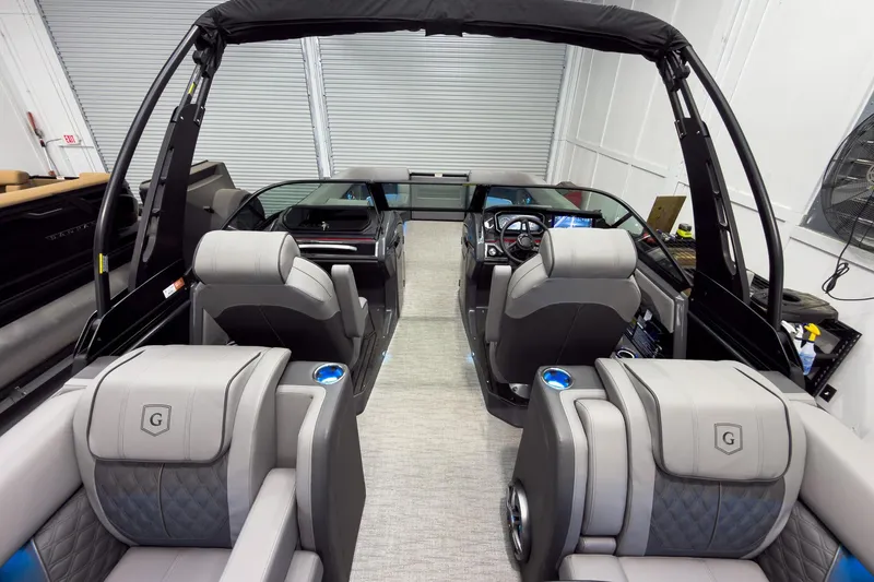 Slide: The Image of Interior of 2026 Godfrey Sanpan 27' Tritoon with luxurious seating and modern dashboard. - 45