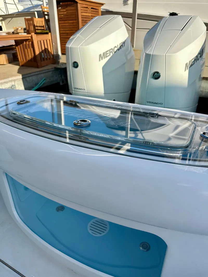 Slide: The Image of 2025 Mag Bay 38 CC boat with dual Mercury engines, sleek design. - 6