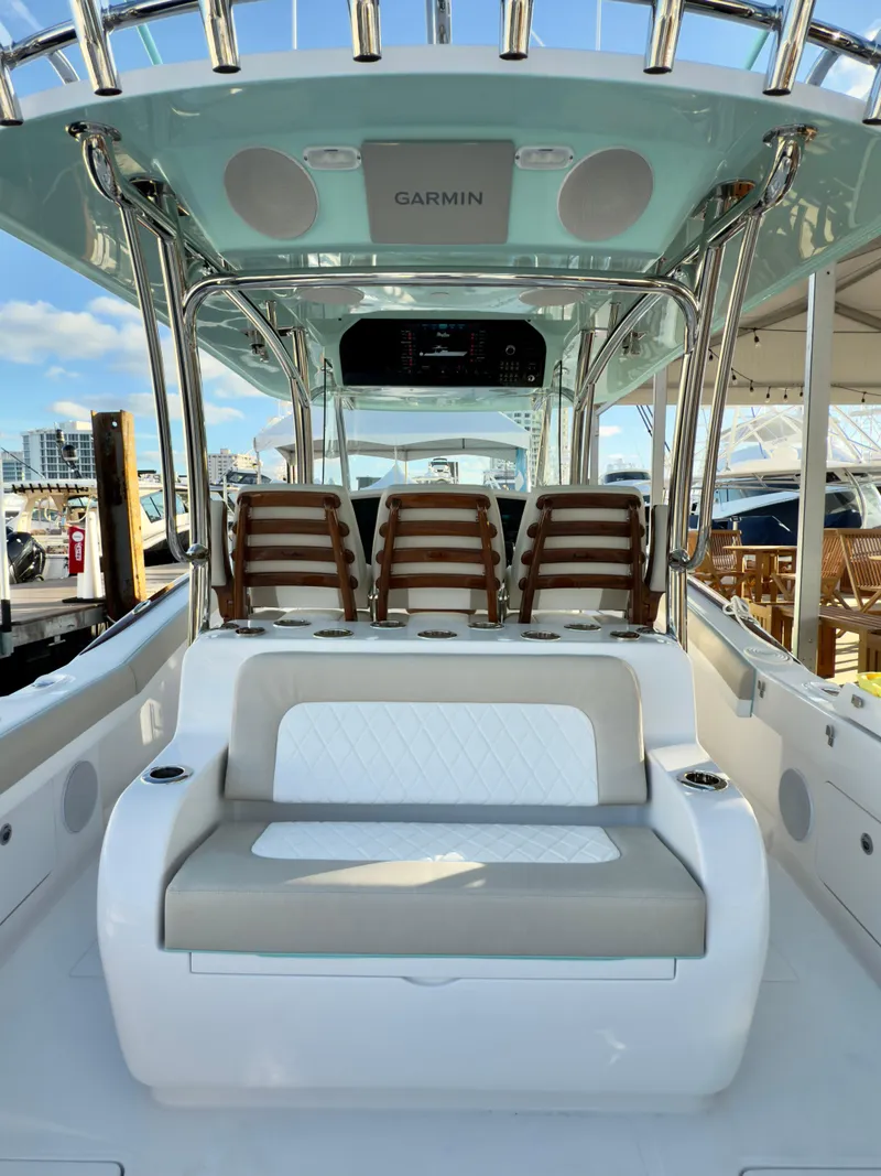Slide: The Image of 2025 Mag Bay 38 CC boat interior with seating and Garmin electronics. - 7