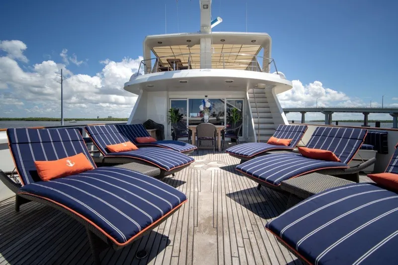Slide: The Image of Luxurious 1984 Lloyds Ships Tri-Deck yacht with striped lounge chairs on deck. - 2