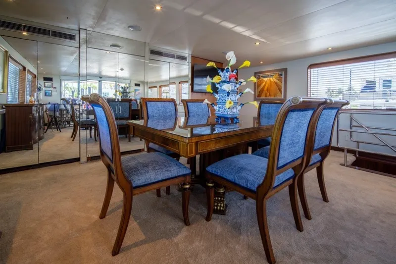 Slide: The Image of Luxurious dining area on 1984 Lloyds Ships Tri-Deck yacht with elegant blue chairs. - 26