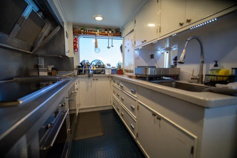 Slide: The Image of Luxurious 1984 Lloyds Ships Tri-Deck yacht kitchen with modern appliances and sleek design. - 30