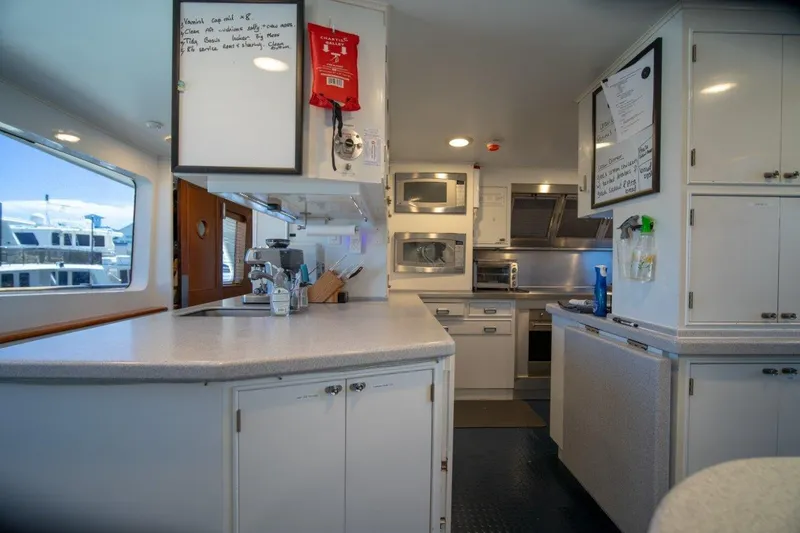 Slide: The Image of Luxurious 1984 Lloyds Ships Tri-Deck yacht kitchen with modern appliances and ample counter space. - 32