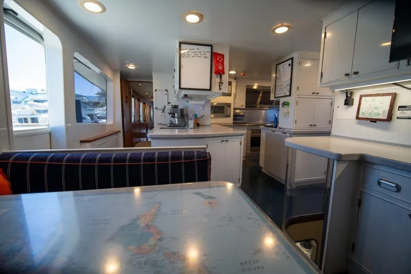 Slide: The Image of Interior of 1984 Lloyds Ships Tri-Deck yacht, featuring a modern kitchen and dining area. - 33