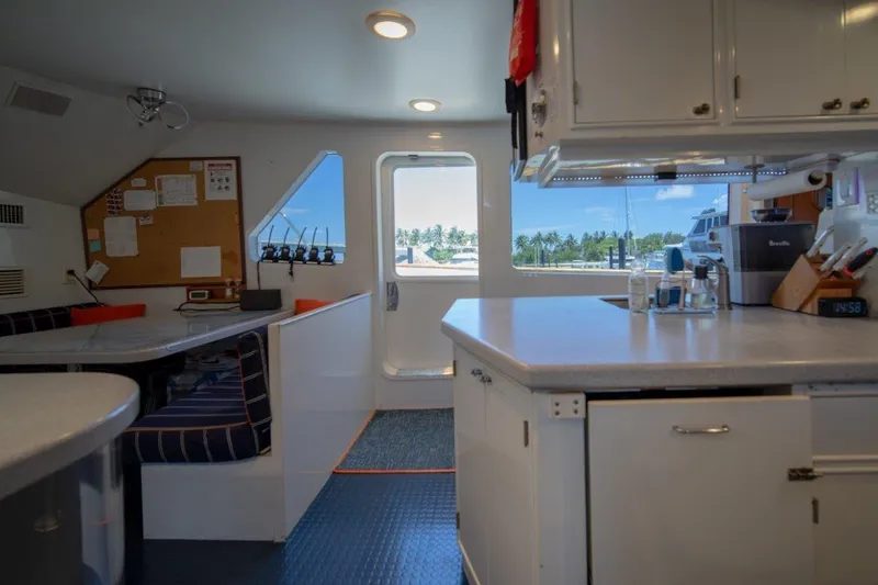 Slide: The Image of Interior of 1984 Lloyds Ships Tri-Deck yacht with kitchen and dining area, featuring ocean view. - 34