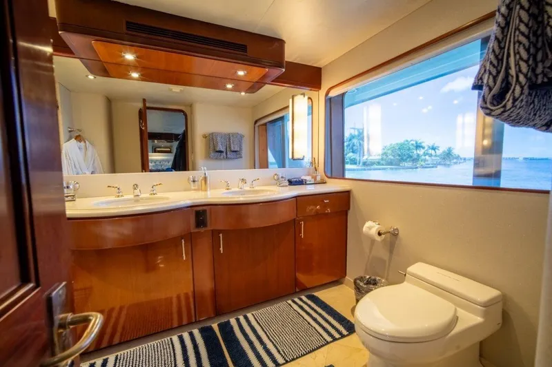 Slide: The Image of Luxurious yacht bathroom with dual sinks, large window, and elegant wood cabinetry on a 1984 Lloyds Ships Tri-Deck. - 36