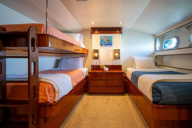 Slide: The Image of Luxurious 1984 Lloyds Ships Tri-Deck yacht cabin with bunk beds and elegant wood finishes. - 40